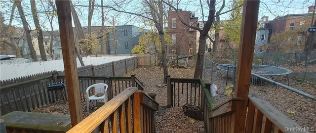 a view of balcony with wooden fence and floor