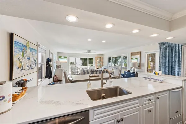 a kitchen with sink stove and cabinets