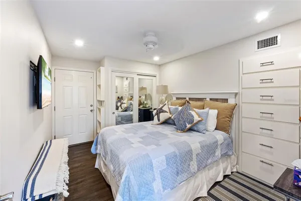 a bedroom with a bed and a flat tv screen