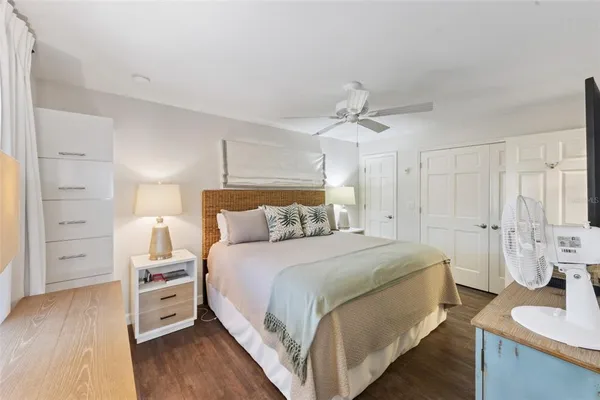 a bed room with a bed and a ceiling fan