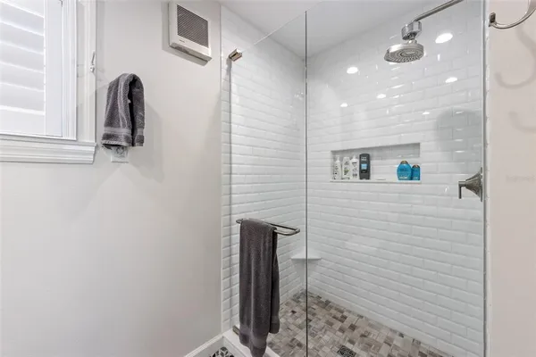 a bathroom with a shower and a sink