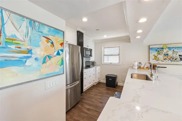 a kitchen with stainless steel appliances a refrigerator and a sink