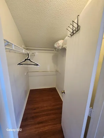 a view of a room with wooden floor