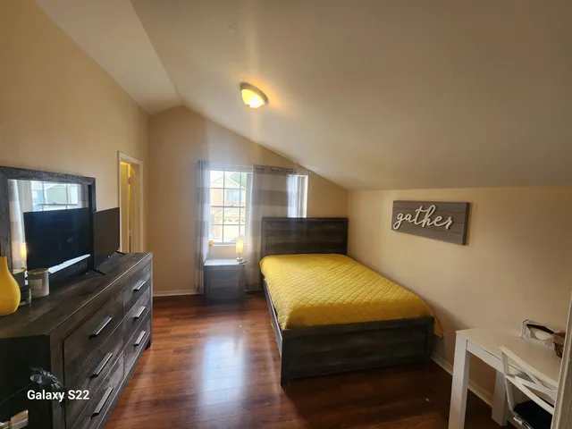 a room with wooden floors and a flat screen tv