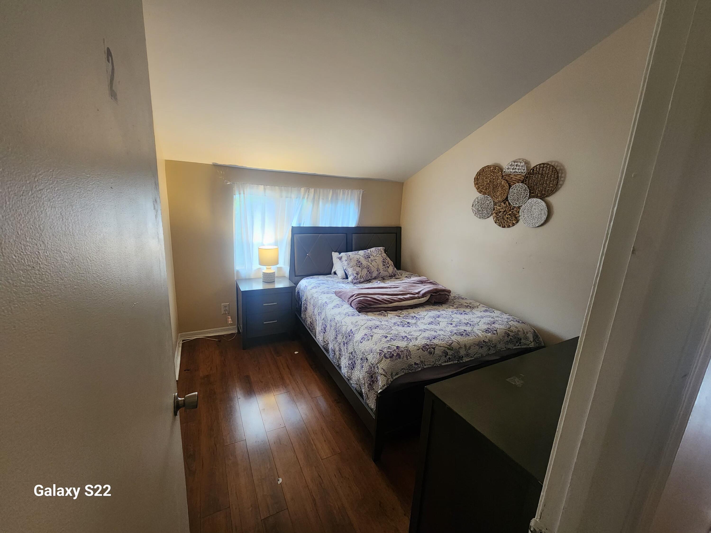 5884 Dewberry Way West Palm Beach, FL 33415 - Photo 16 of 26 a bedroom with a bed and cabinets