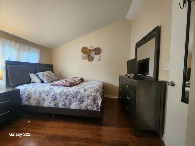 a bedroom with a bed and a tv