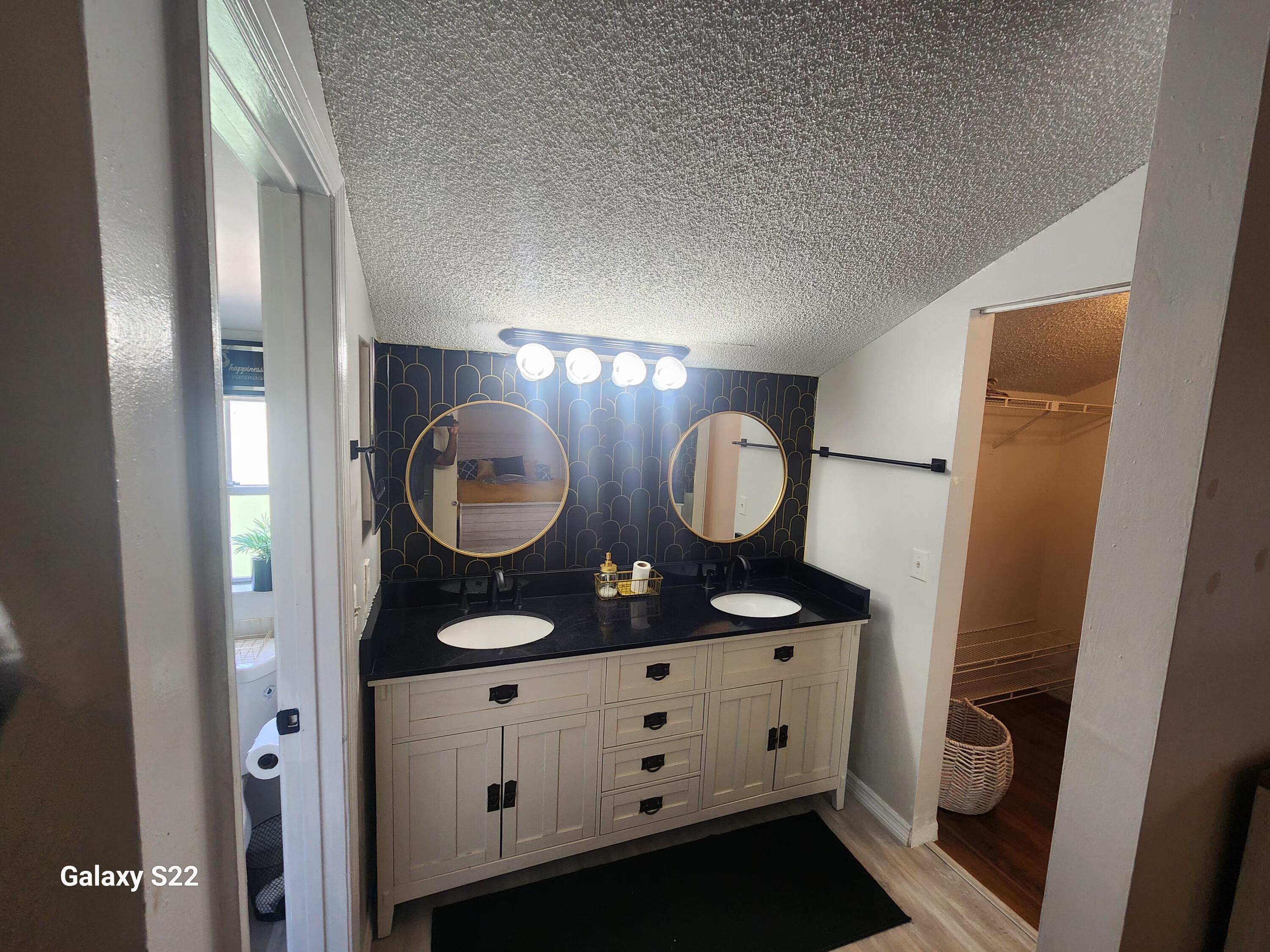 5884 Dewberry Way West Palm Beach, FL 33415 - Photo 21 of 26 a bathroom with double vanity and a mirror