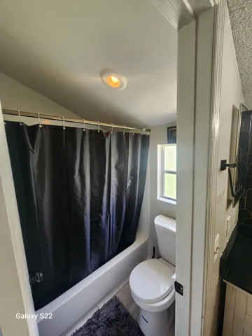 a bathroom with a toilet and a shower