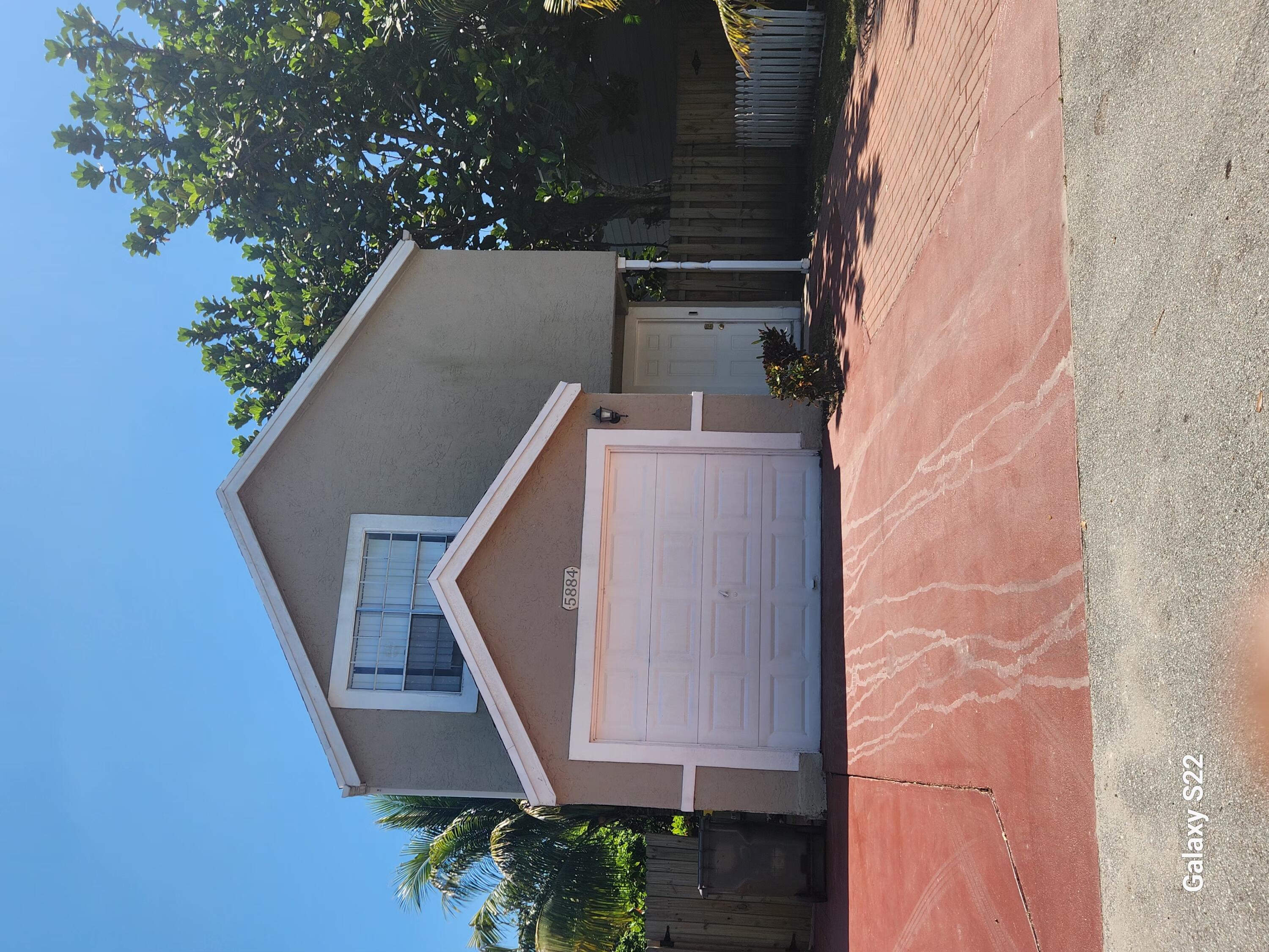 5884 Dewberry Way West Palm Beach, FL 33415 - Photo 4 of 26 a front view of a house with a yard
