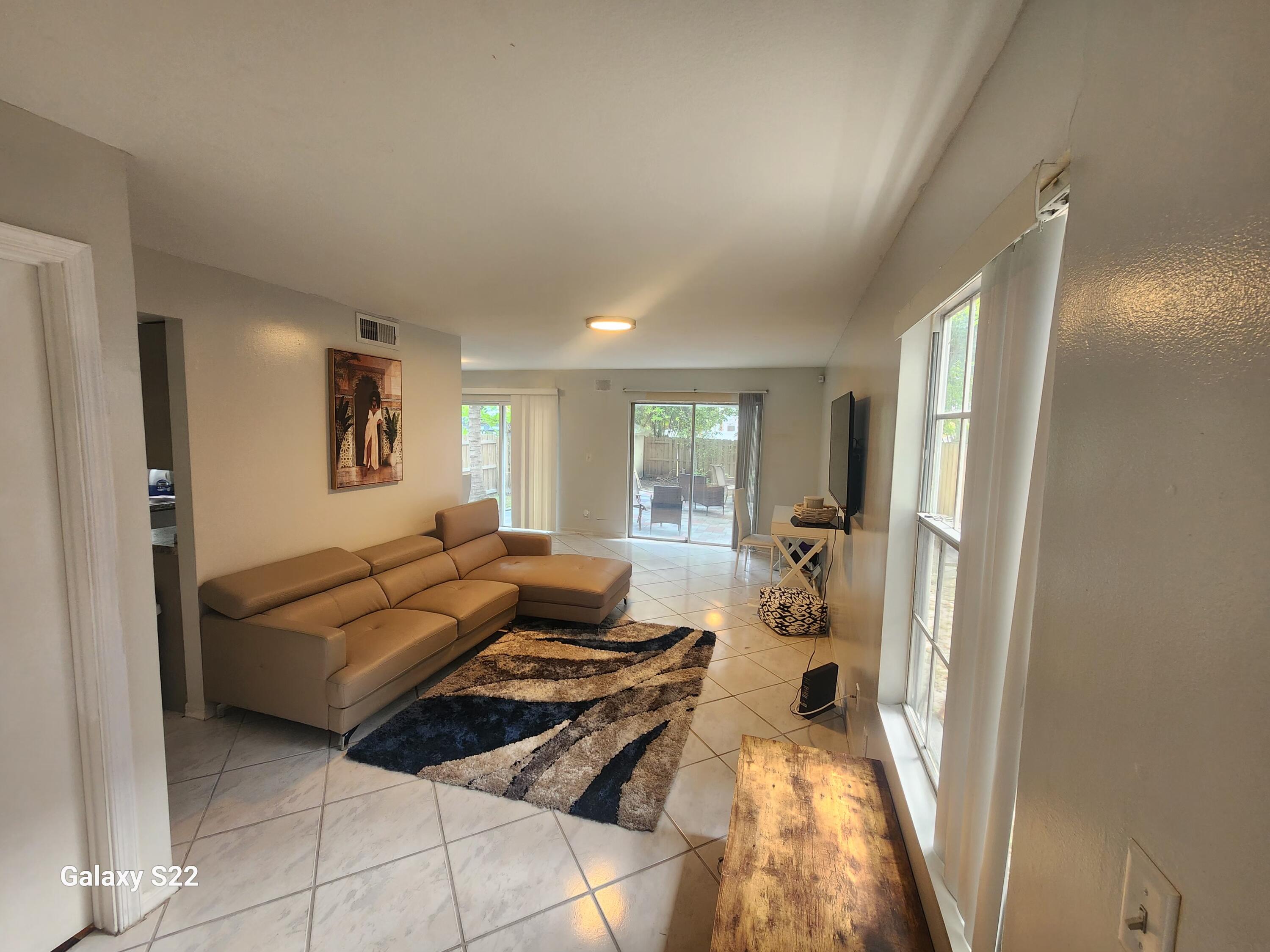 5884 Dewberry Way West Palm Beach, FL 33415 - Photo 8 of 26 a living room with furniture and a large window