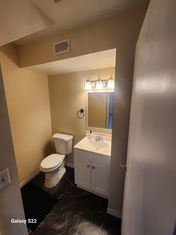a bathroom with a sink toilet and mirror