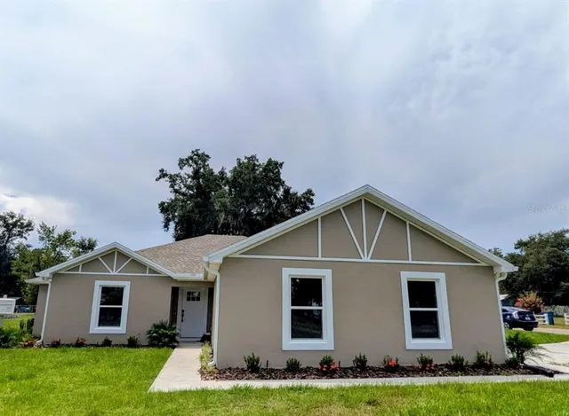 a front view of house with yard and green space