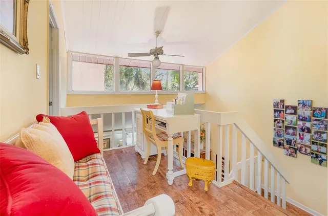 a living room with furniture fireplace and a large window
