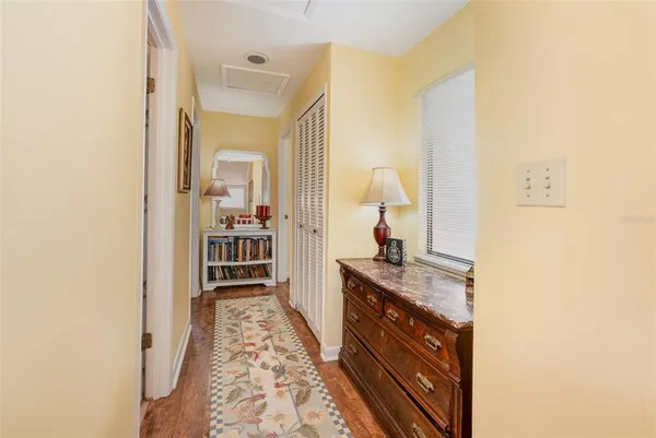 a hallway with a sink and a mirror