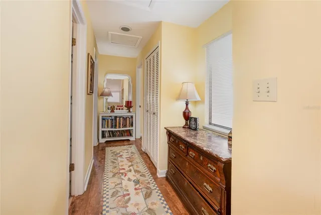 a hallway with a sink and a mirror