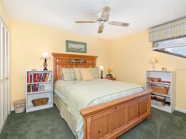 a bed room with a bed and a book shelf