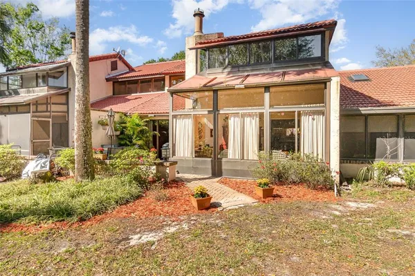 a view of a house with backyard porch and sitting area