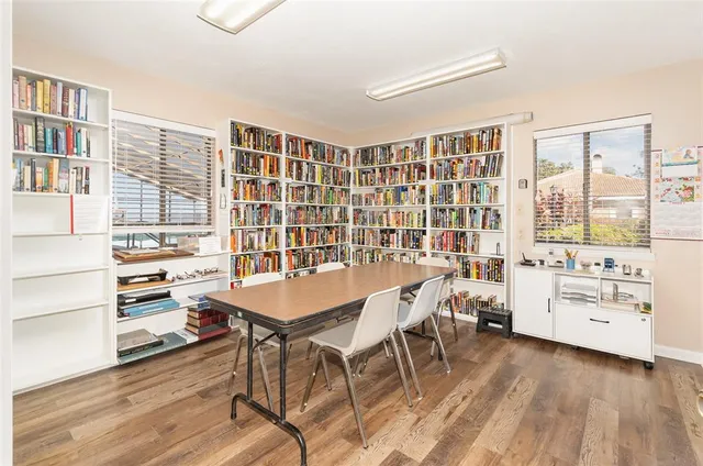 a view of a workspace with furniture and a window