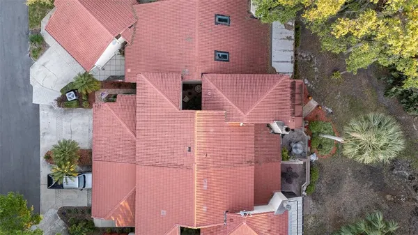 an aerial view of a house with a yard and potted plants