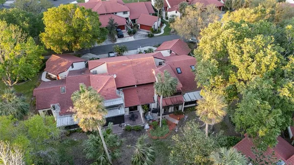 an aerial view of a house with a yard