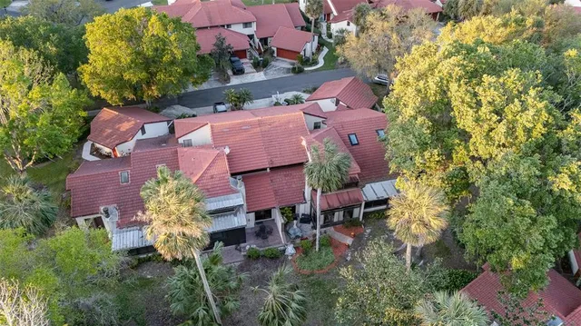 an aerial view of a house with a yard