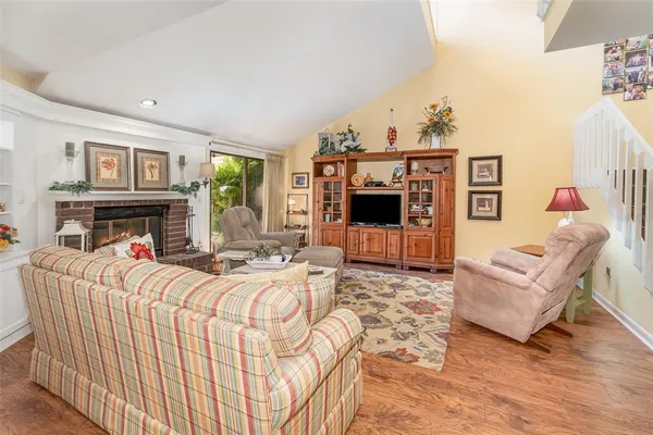 a living room with fireplace furniture and a flat screen tv
