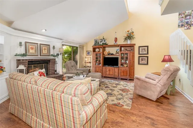a living room with fireplace furniture and a flat screen tv
