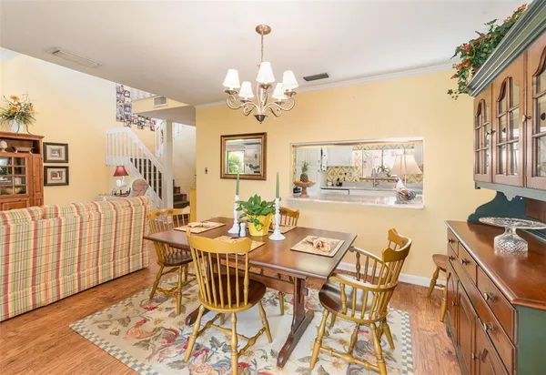 a view of a dining room with furniture and a chandelier