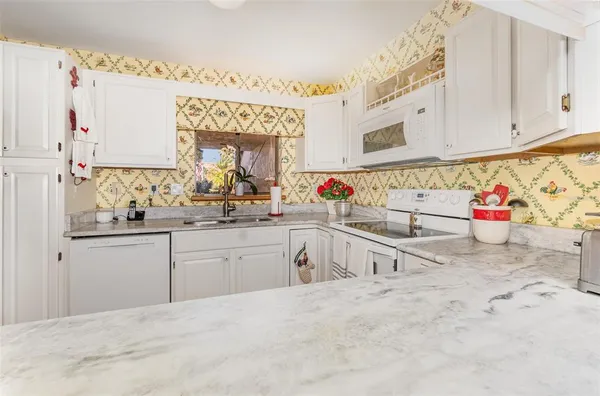 a kitchen with sink cabinets and window