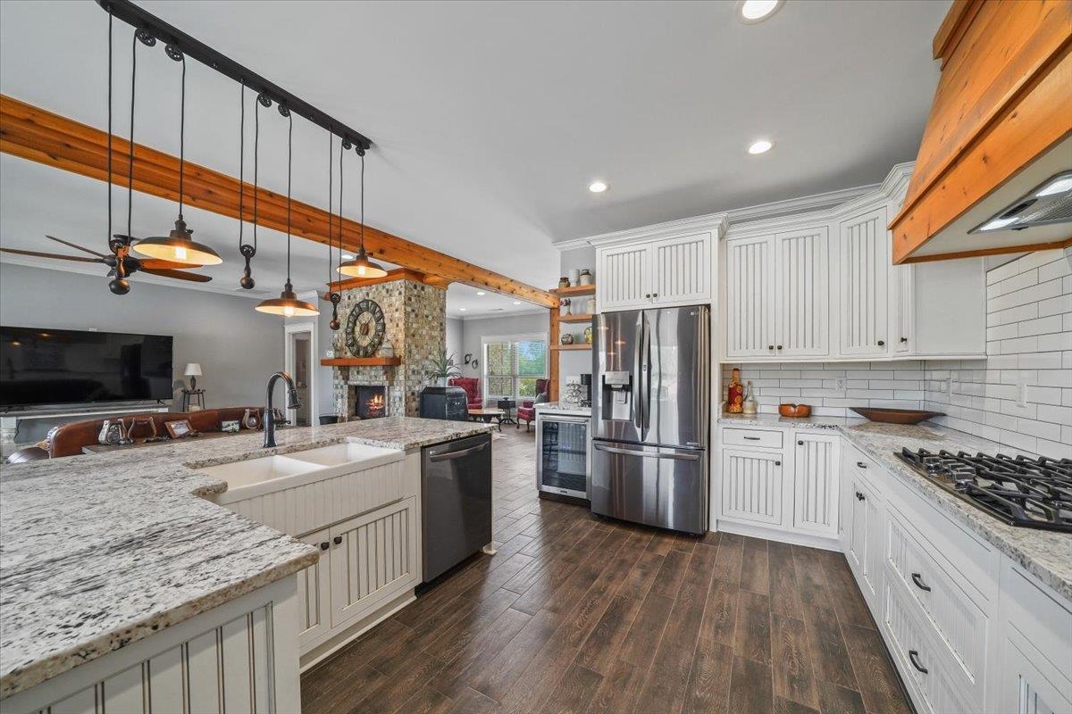 4374 Gainsville Road Mason, TN 38049 - Photo 40 of 40 Kitchen with open floor plan, white cabinetry, light stone countertops, beam ceiling, and recessed lighting
