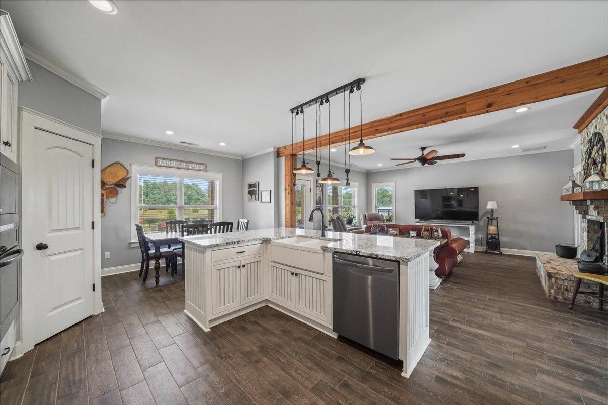 4374 Gainsville Road Mason, TN 38049 - Photo 15 of 40 Kitchen featuring hanging light fixtures, light stone counters, appliances with stainless steel finishes, recessed lighting, and a center island with sink