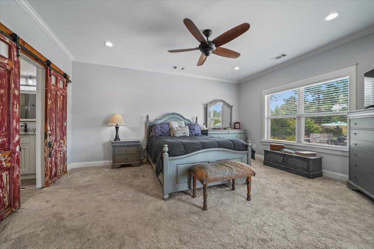 4374 Gainsville Road Mason, TN 38049 - Photo 16 of 40 Bedroom featuring ornamental molding, a barn door, light carpet, a ceiling fan, and recessed lighting