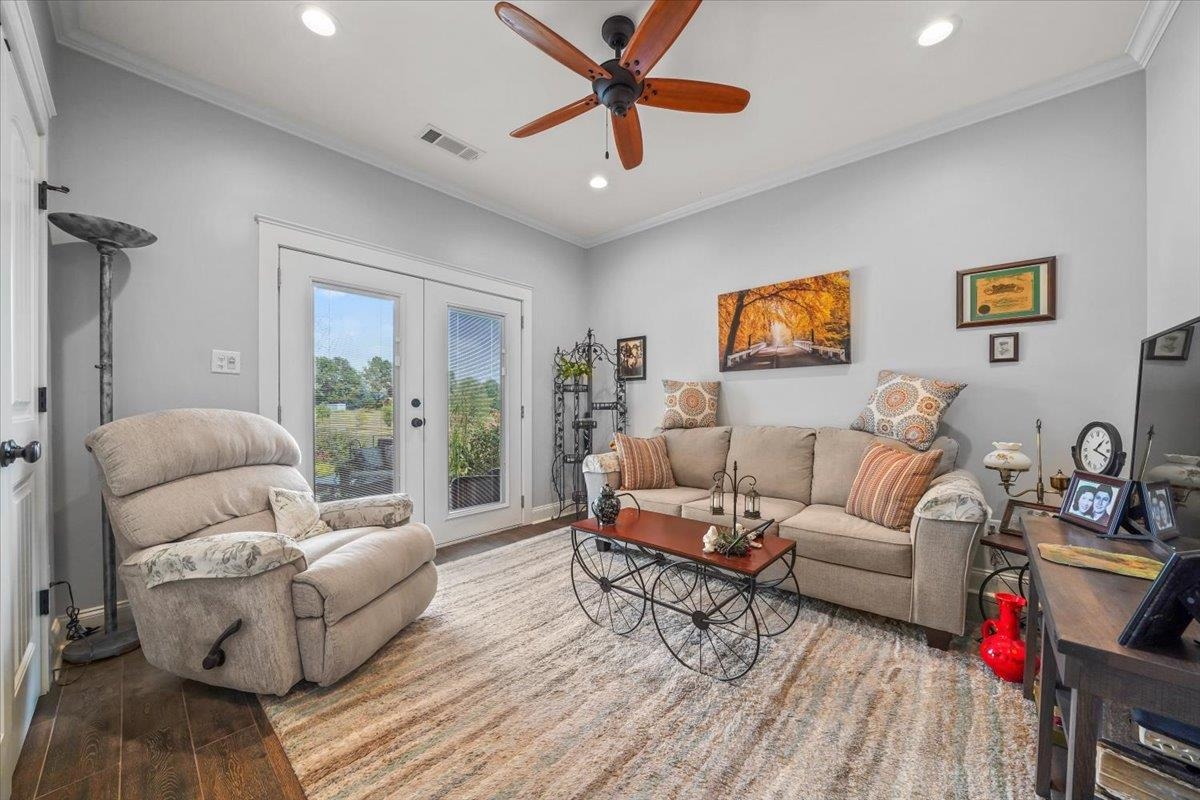 4374 Gainsville Road Mason, TN 38049 - Photo 21 of 40 Living area with ornamental molding, wood finished floors, recessed lighting, french doors, and a ceiling fan