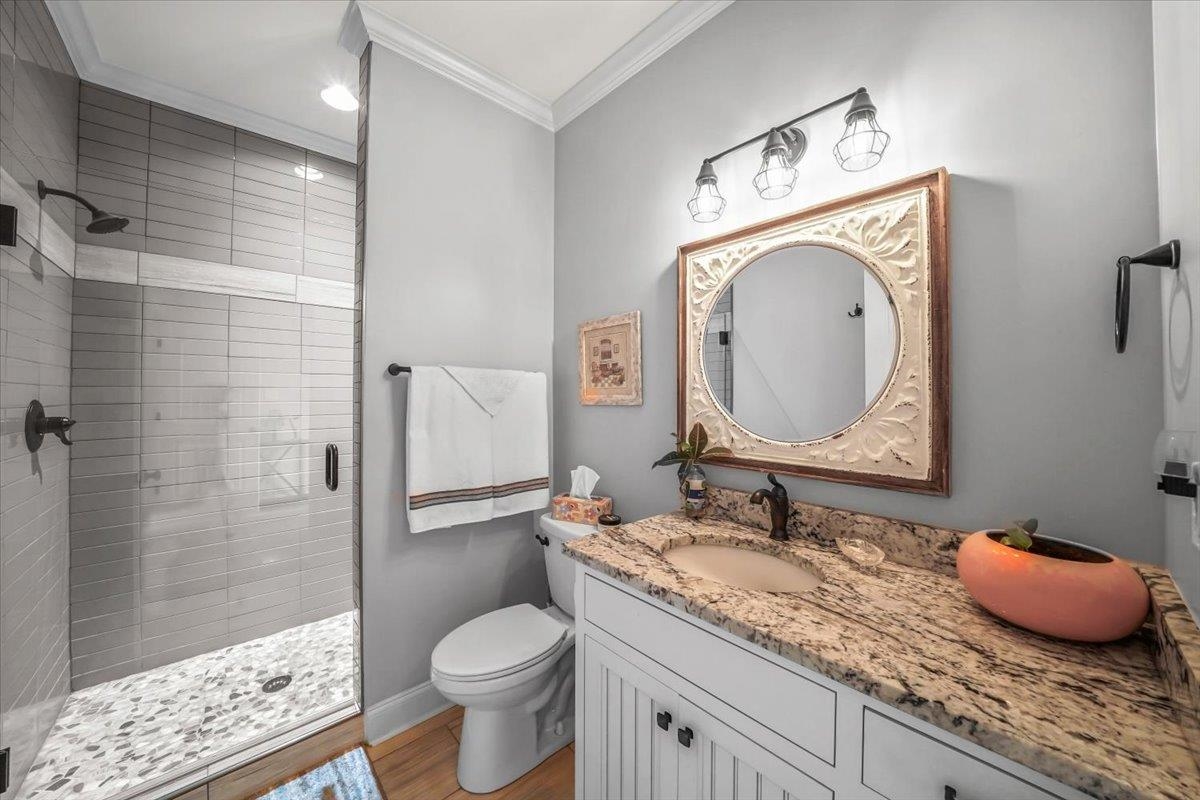 4374 Gainsville Road Mason, TN 38049 - Photo 23 of 40 Full bathroom with a shower stall, vanity, ornamental molding, and dark wood-style floors