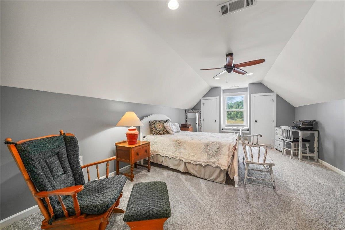 4374 Gainsville Road Mason, TN 38049 - Photo 25 of 40 Carpeted bedroom with vaulted ceiling and a ceiling fan