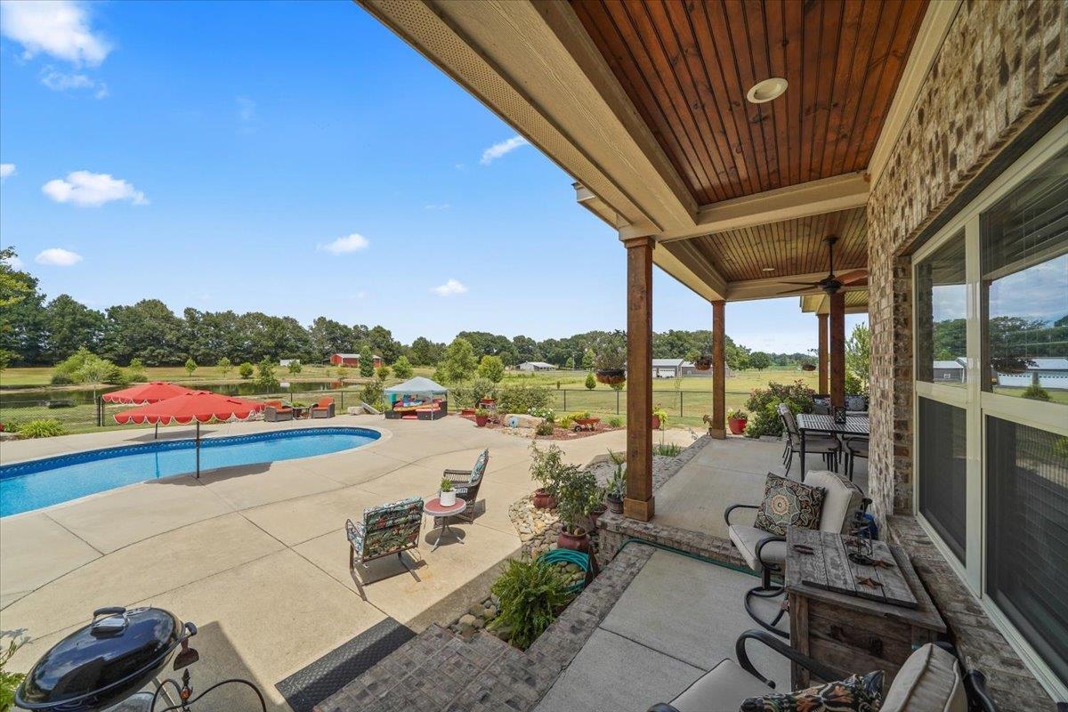 4374 Gainsville Road Mason, TN 38049 - Photo 33 of 40 Porch featuring an outdoor pool and view of wooded area