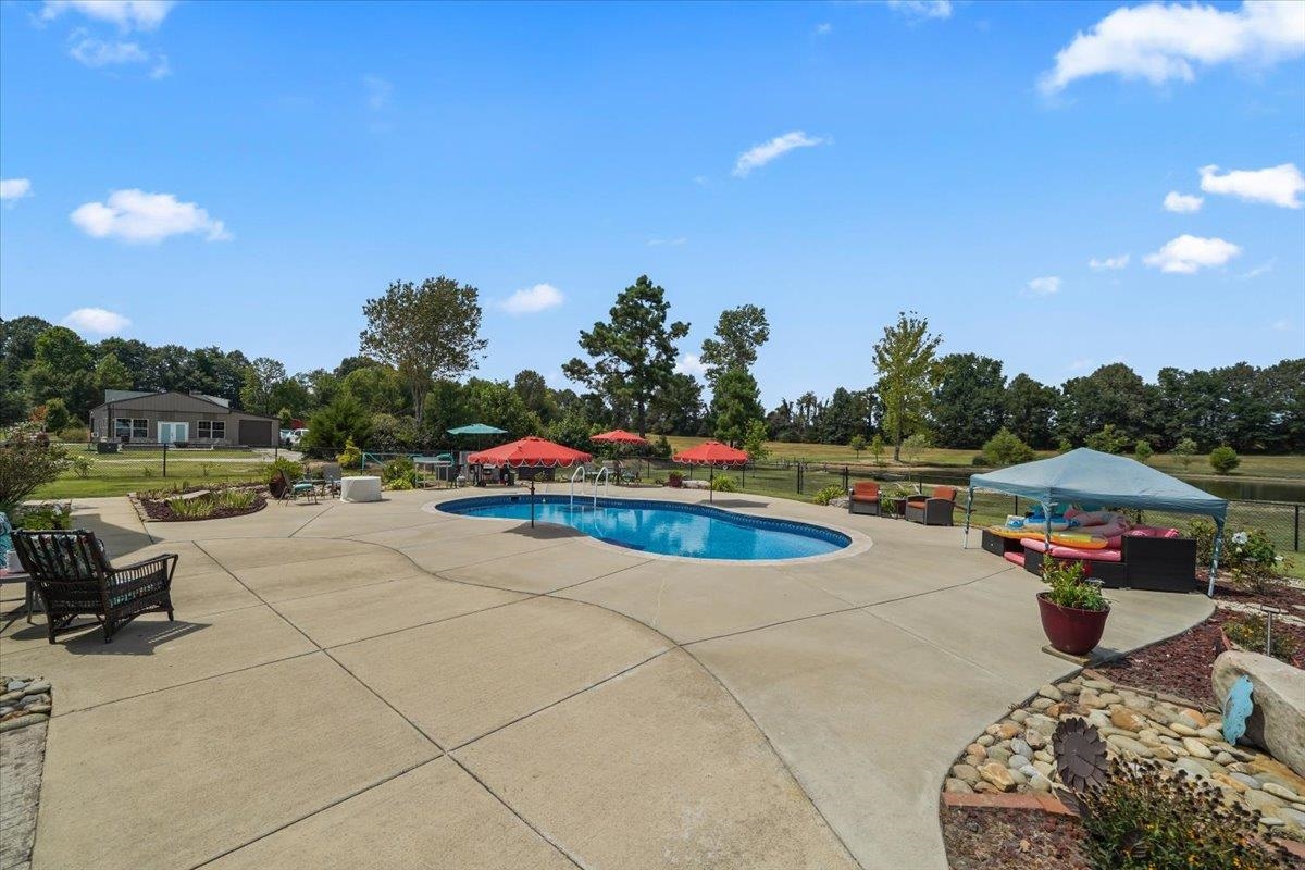 4374 Gainsville Road Mason, TN 38049 - Photo 34 of 40 View of pool featuring a patio and view of wooded area