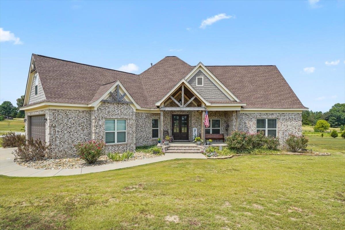 4374 Gainsville Road Mason, TN 38049 - Photo 4 of 40 Craftsman-style home with covered porch, a front yard, a garage, brick siding, and roof with shingles