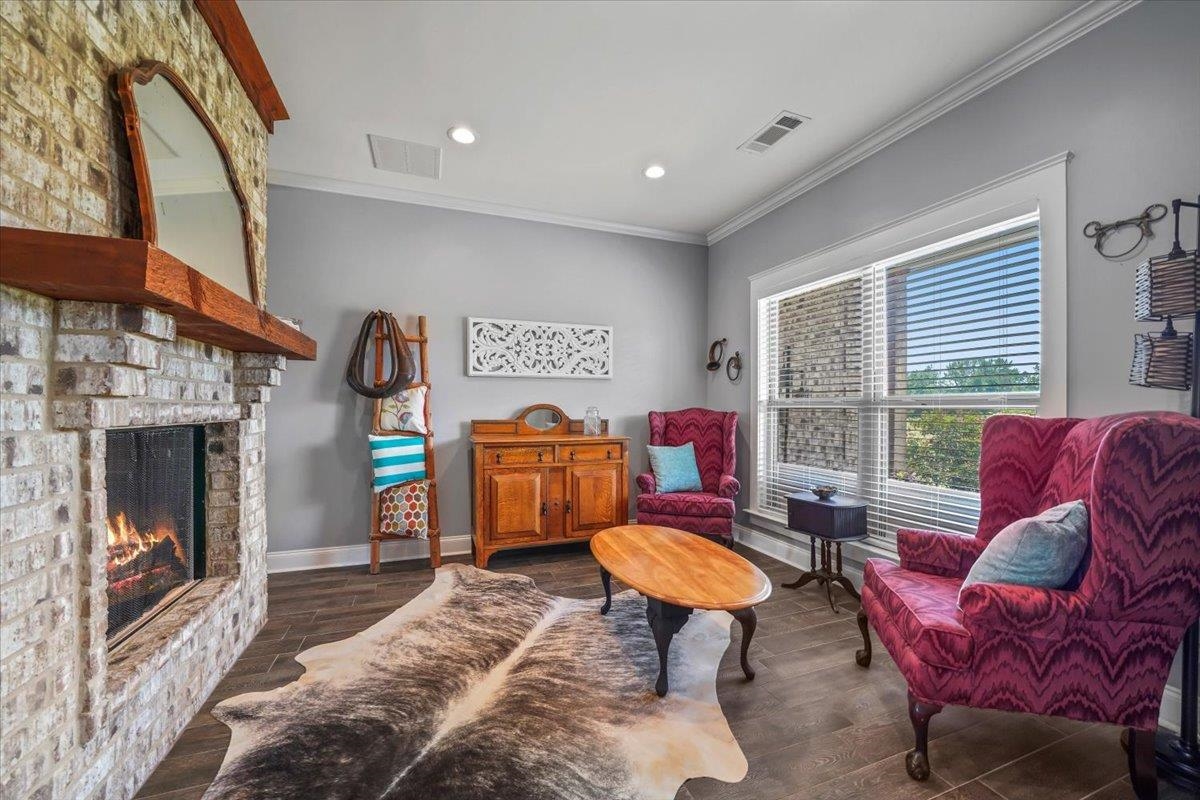4374 Gainsville Road Mason, TN 38049 - Photo 8 of 40 Converted Dining room to Living area featuring dark wood finished floors, ornamental molding, recessed lighting, and a brick fireplace