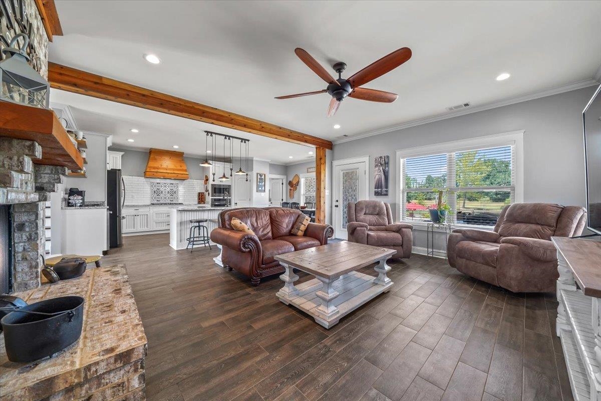 4374 Gainsville Road Mason, TN 38049 - Photo 10 of 40 Living area with crown molding, recessed lighting, dark wood-style floors, a ceiling fan, and beamed ceiling