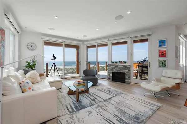 a living room with fireplace furniture and a large window