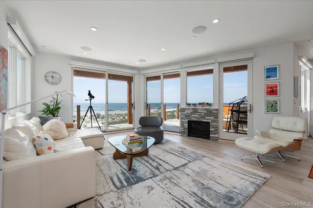 a living room with fireplace furniture and a large window