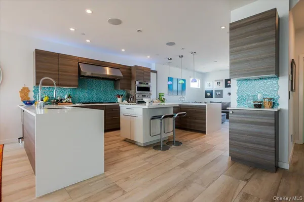 a kitchen with stainless steel appliances kitchen island granite countertop a stove and a sink