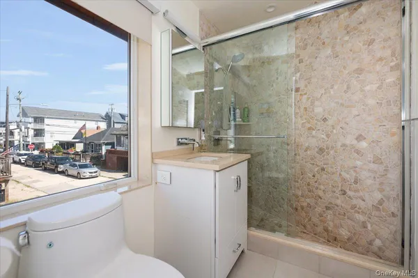 a bathroom with a sink a mirror and a shower