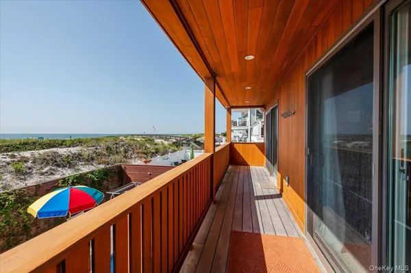 a view of balcony with wooden floor and seating space