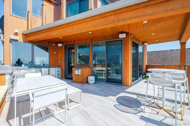 a white building with a table and chairs in patio