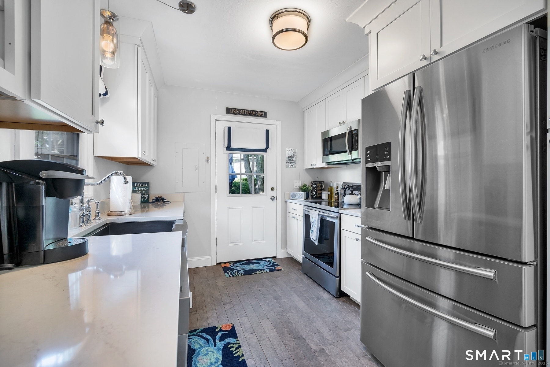 76 South Edgewood Road East Lyme, CT 06357 - Photo 12 of 18 a kitchen with a refrigerator stainless steel appliances wooden floor and cabinets
