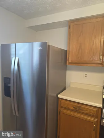a view of a refrigerator in kitchen