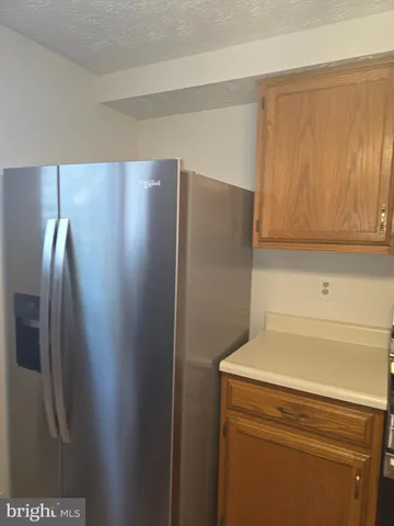 a view of a refrigerator in kitchen