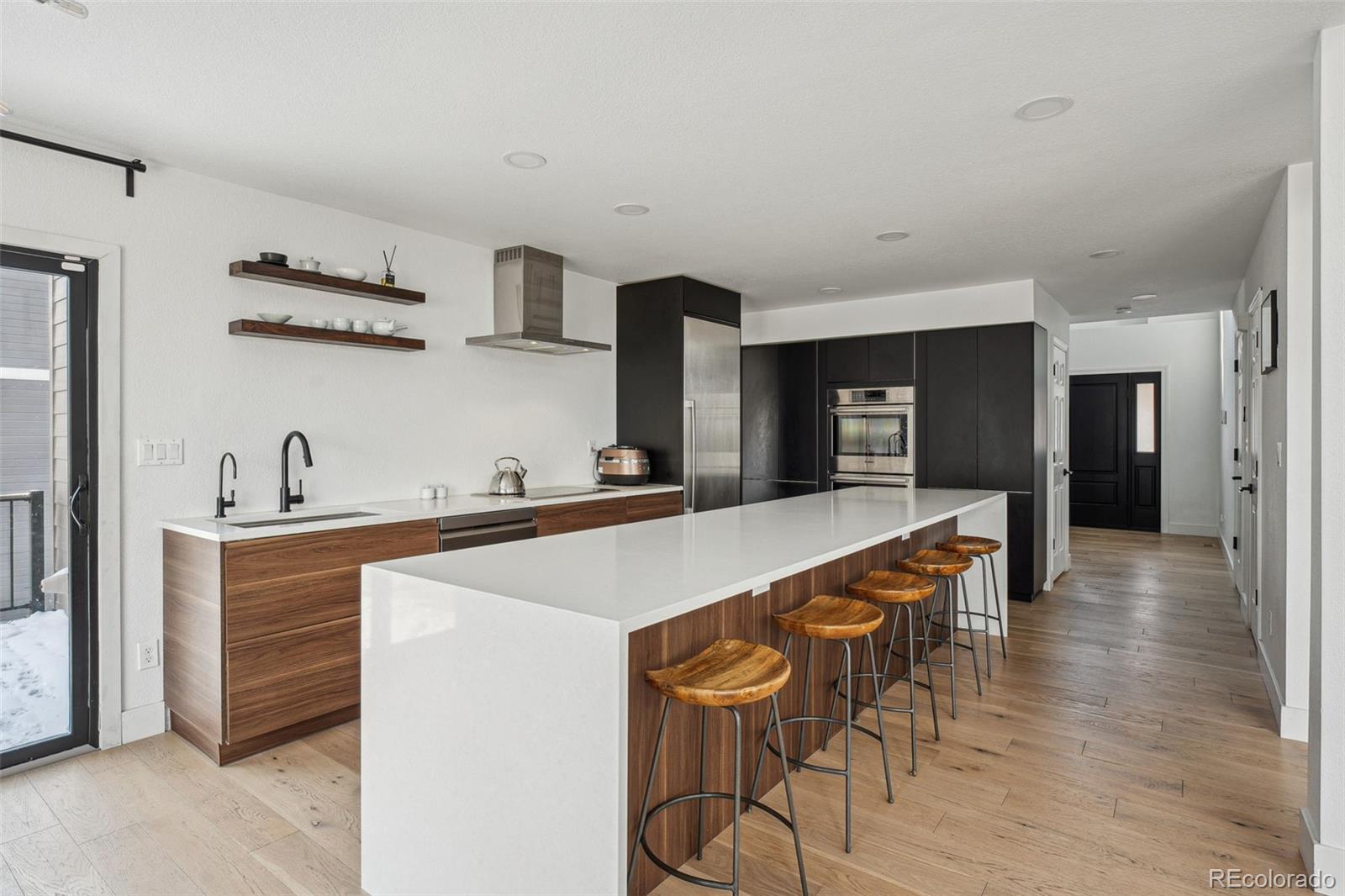 1711 Spring Water Lane Highlands Ranch, CO 80129 - Photo 11 of 48 a large kitchen with a table and chairs